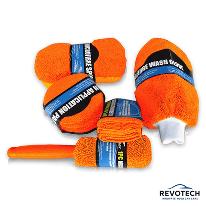 Orangenes 9-teiliges Reinigungsset mit allen Komponenten flach angeordnet – ideal für komplette Innen- und Außenreinigung.